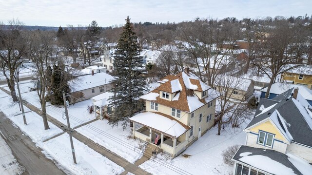 snowy aerial view featuring a residential view