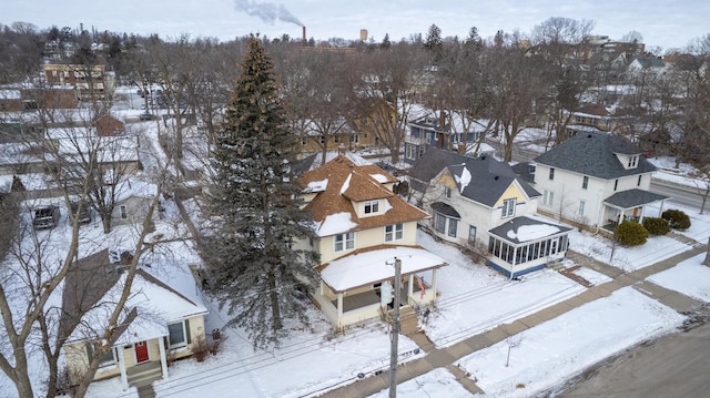 snowy aerial view with a residential view