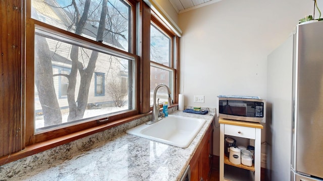 kitchen with stainless steel appliances, light countertops, and a sink