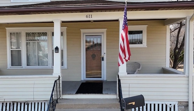 view of exterior entry with covered porch