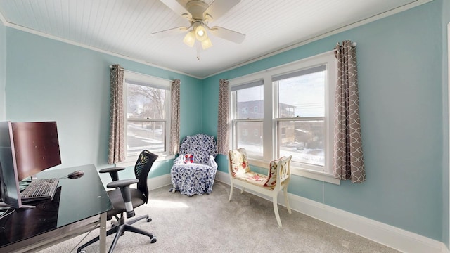 carpeted office space with a ceiling fan, baseboards, and ornamental molding