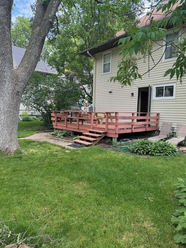 back of property with a yard and a deck