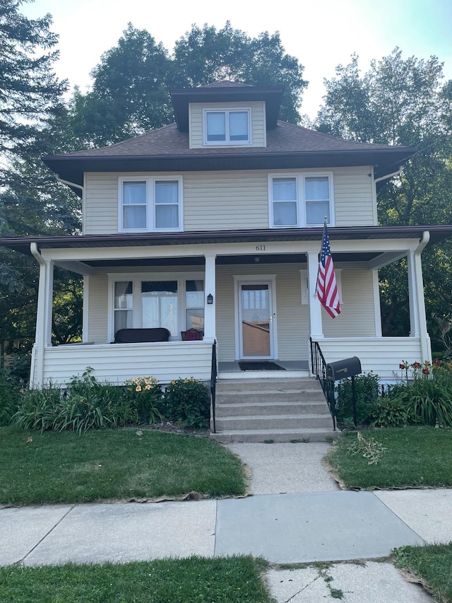 american foursquare style home with covered porch