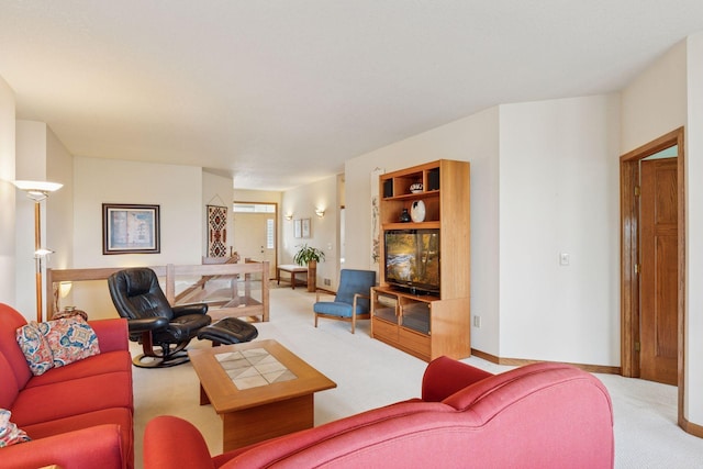 living area with baseboards and carpet flooring