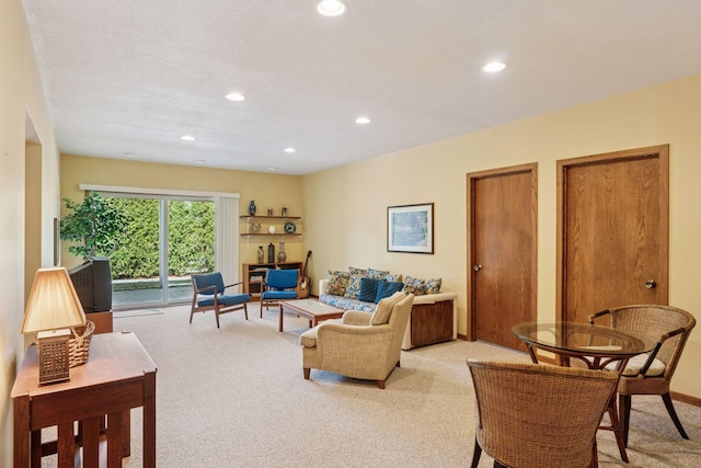 living area with recessed lighting, baseboards, and light carpet