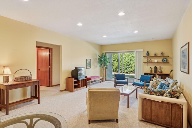 living area featuring recessed lighting, baseboards, and light carpet