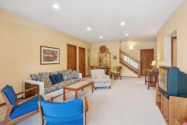 living room featuring recessed lighting, baseboards, carpet floors, and stairway