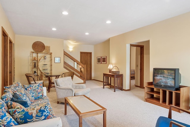 living room with stairs, recessed lighting, light colored carpet, and baseboards