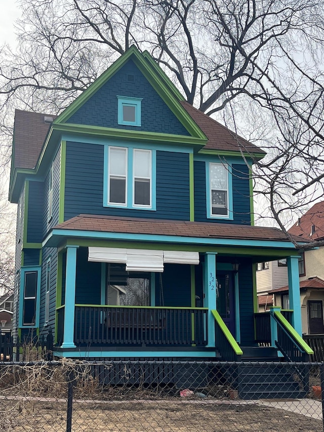 view of front of home featuring roof with shingles and a porch