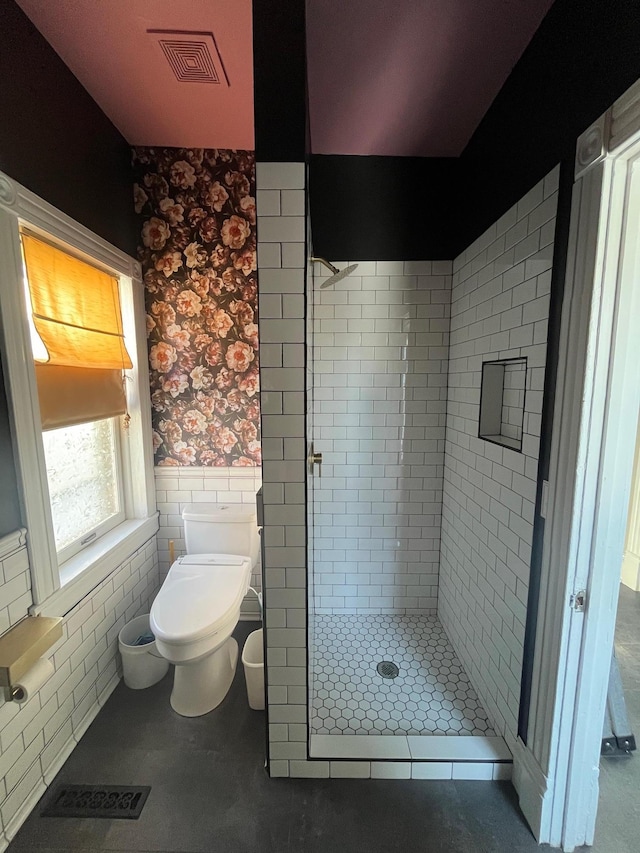 bathroom featuring visible vents, toilet, a wainscoted wall, and a shower stall