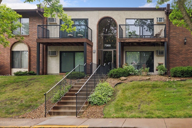 view of front of property with brick siding and a front lawn