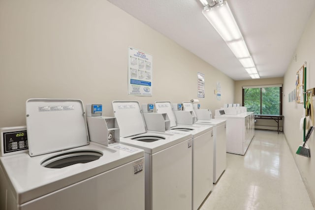 shared laundry area featuring washing machine and dryer and light floors