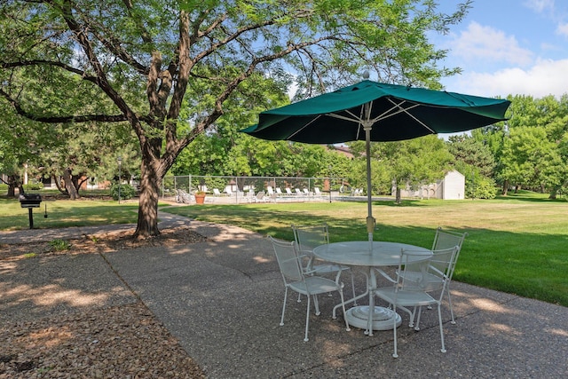 view of patio / terrace with outdoor dining area and fence