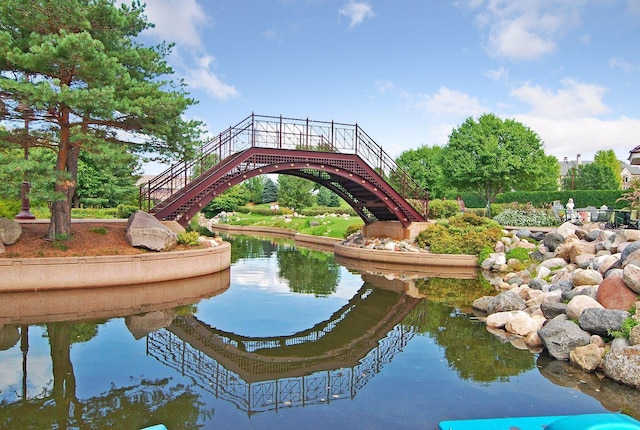 view of home's community with stairs and a water view