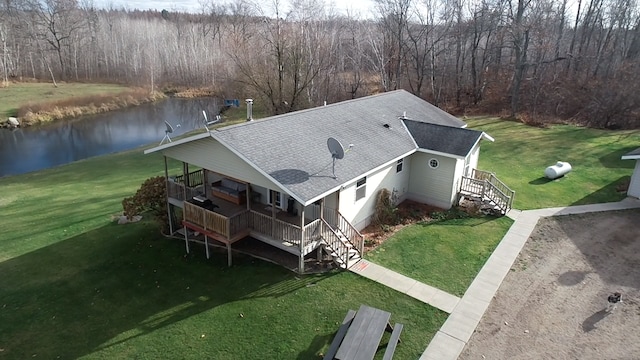 aerial view with a wooded view and a water view