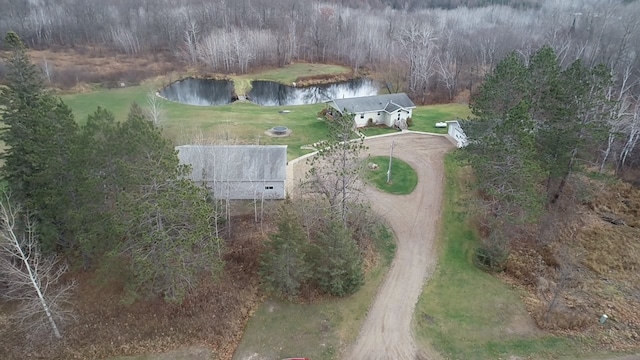 aerial view featuring a wooded view and a water view