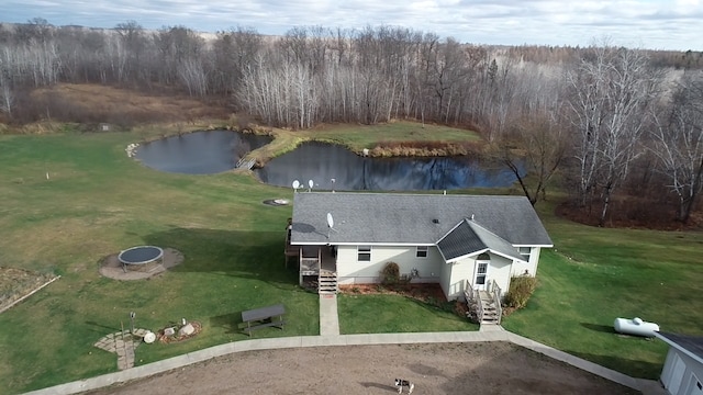 birds eye view of property featuring a forest view and a water view