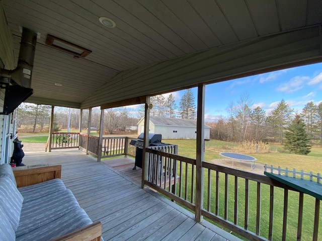 wooden terrace with a lawn