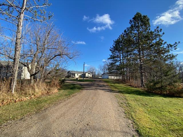 view of street with dirt driveway