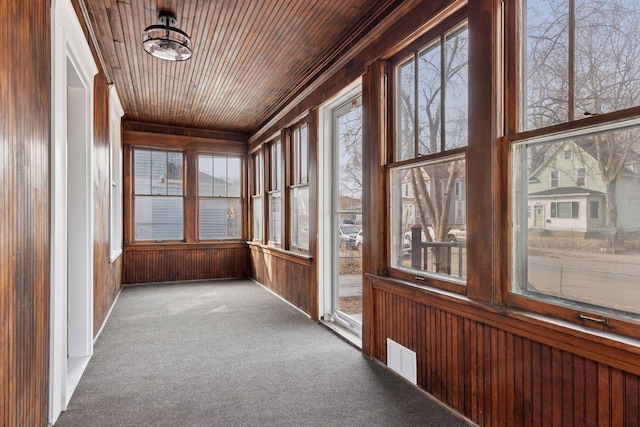 unfurnished sunroom with visible vents and wooden ceiling