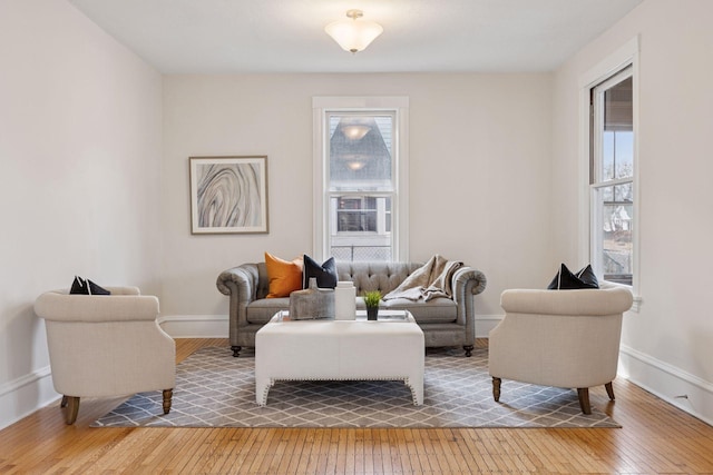 living area featuring light wood finished floors and baseboards