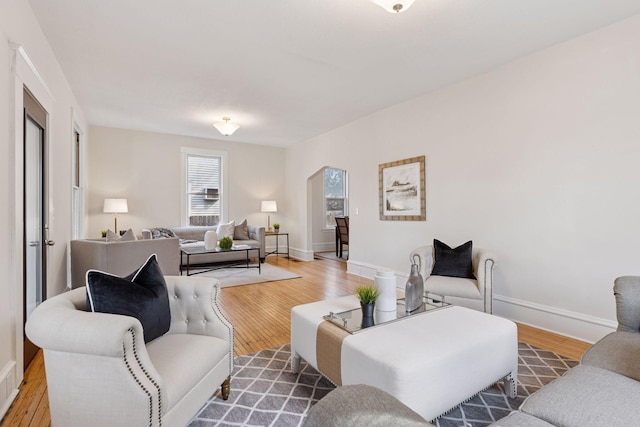 living room with baseboards and wood finished floors