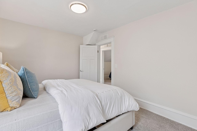 carpeted bedroom featuring visible vents and baseboards