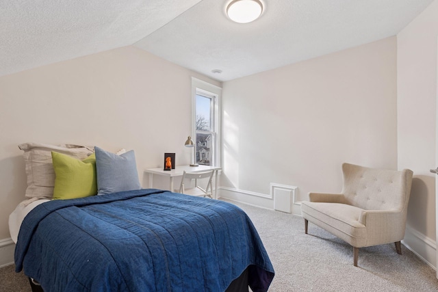 carpeted bedroom featuring baseboards, a textured ceiling, and vaulted ceiling