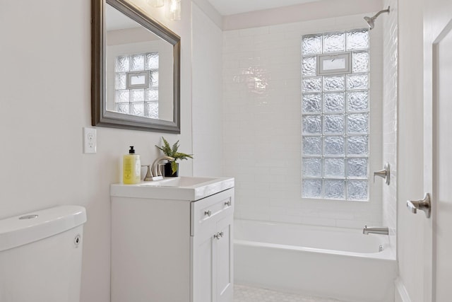 full bathroom featuring vanity, washtub / shower combination, and toilet