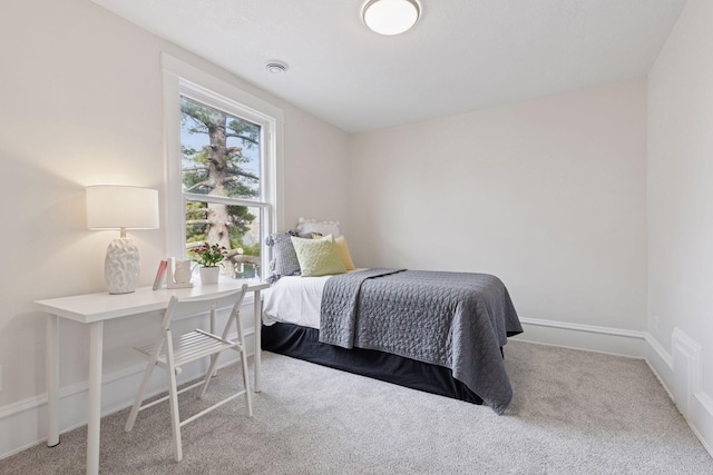 carpeted bedroom featuring visible vents and baseboards