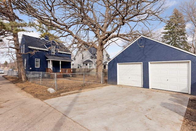 exterior space with concrete driveway and fence