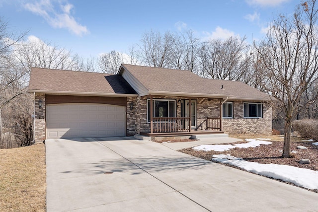 ranch-style home with brick siding, concrete driveway, roof with shingles, covered porch, and an attached garage