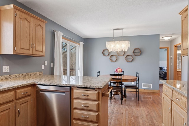 kitchen with visible vents, a peninsula, light wood-style floors, a notable chandelier, and a textured ceiling