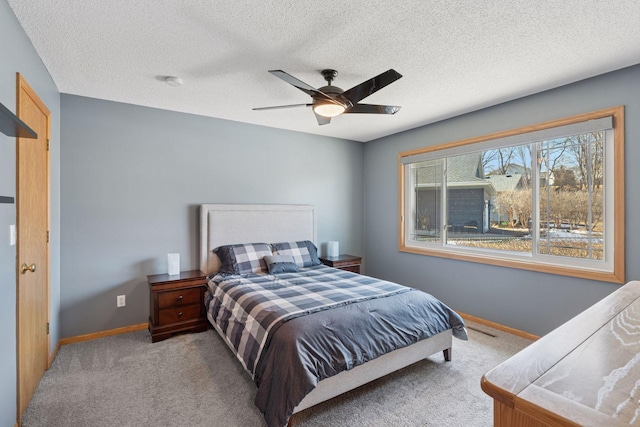 bedroom with carpet flooring, ceiling fan, a textured ceiling, and baseboards