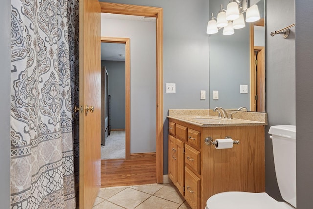 bathroom featuring a shower with shower curtain, toilet, vanity, and tile patterned flooring