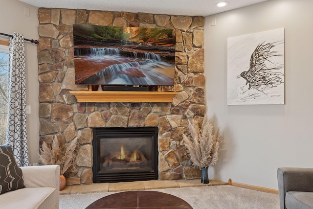 interior details featuring a stone fireplace, baseboards, and carpet floors