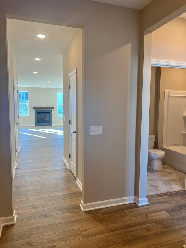 hall with recessed lighting, baseboards, and wood finished floors