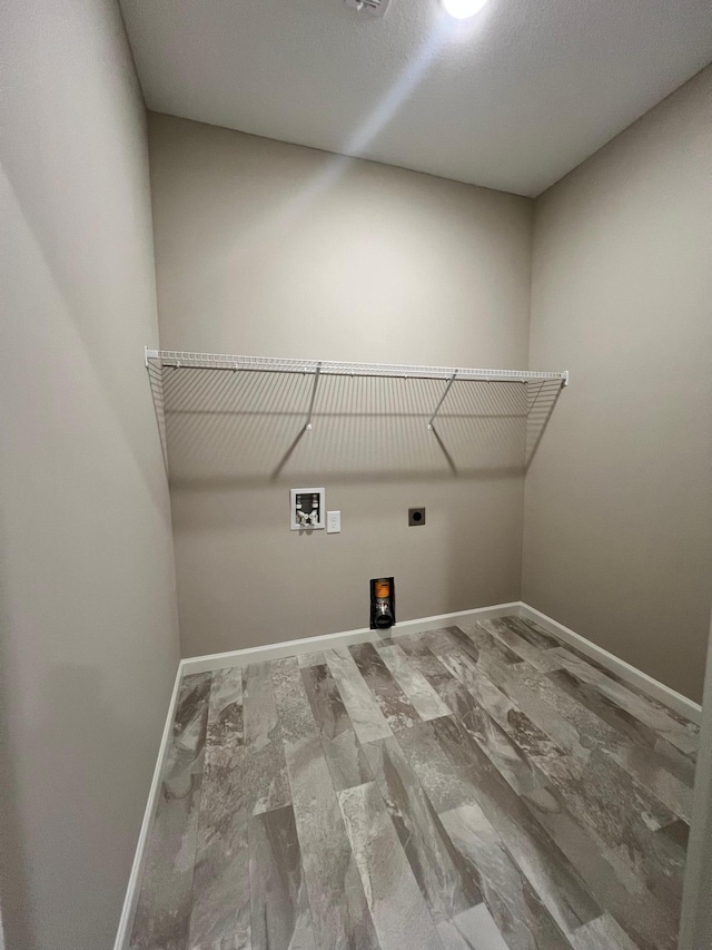 clothes washing area featuring electric dryer hookup, baseboards, washer hookup, and laundry area