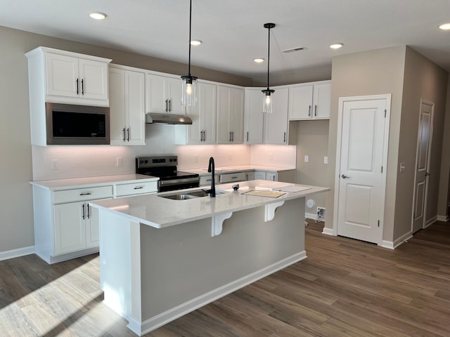 kitchen featuring visible vents, under cabinet range hood, a sink, stainless steel electric range, and white cabinets