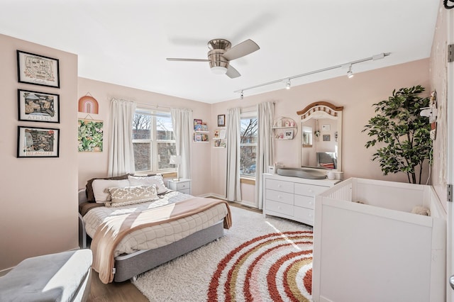 bedroom with light wood-style flooring and a ceiling fan