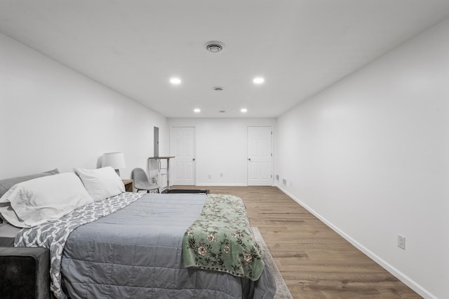 bedroom featuring recessed lighting, baseboards, visible vents, and wood finished floors