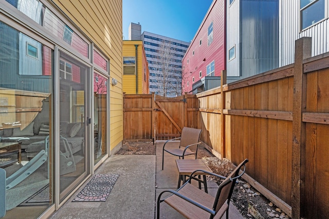 view of patio featuring a gate and fence