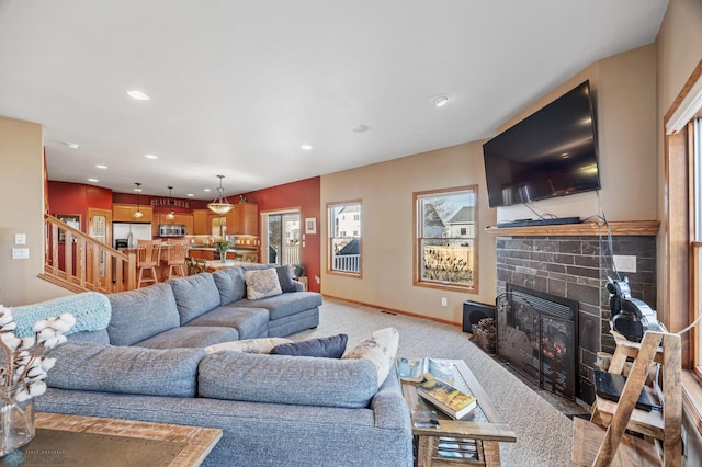 living area featuring recessed lighting, carpet, a fireplace, baseboards, and stairs