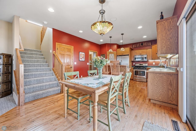 dining space with recessed lighting, light wood-style flooring, stairway, and visible vents