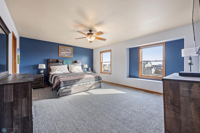 carpeted bedroom featuring visible vents, baseboards, and ceiling fan