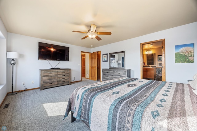 bedroom with visible vents, baseboards, carpet, ensuite bathroom, and a ceiling fan