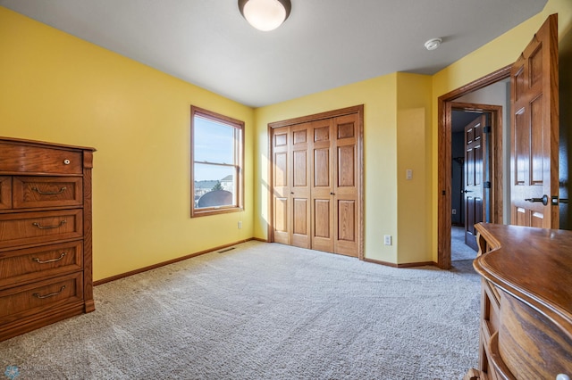 bedroom featuring baseboards, carpet floors, a closet, and visible vents