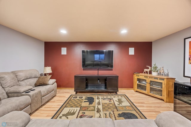 living room featuring recessed lighting, baseboards, and wood finished floors