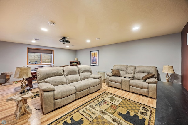 living room with recessed lighting and wood finished floors