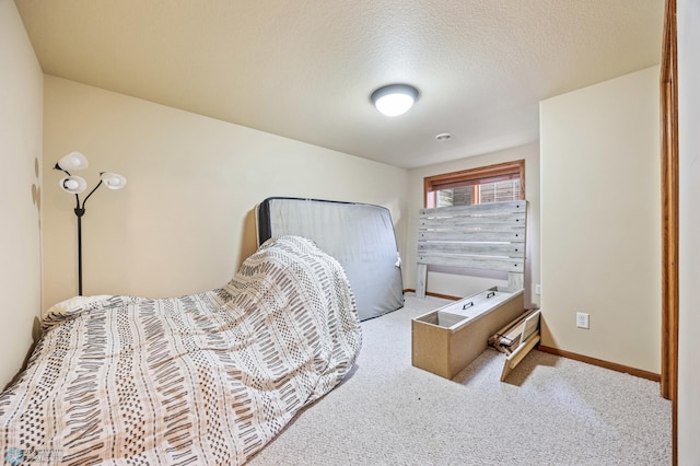 bedroom featuring baseboards, carpet floors, and a textured ceiling